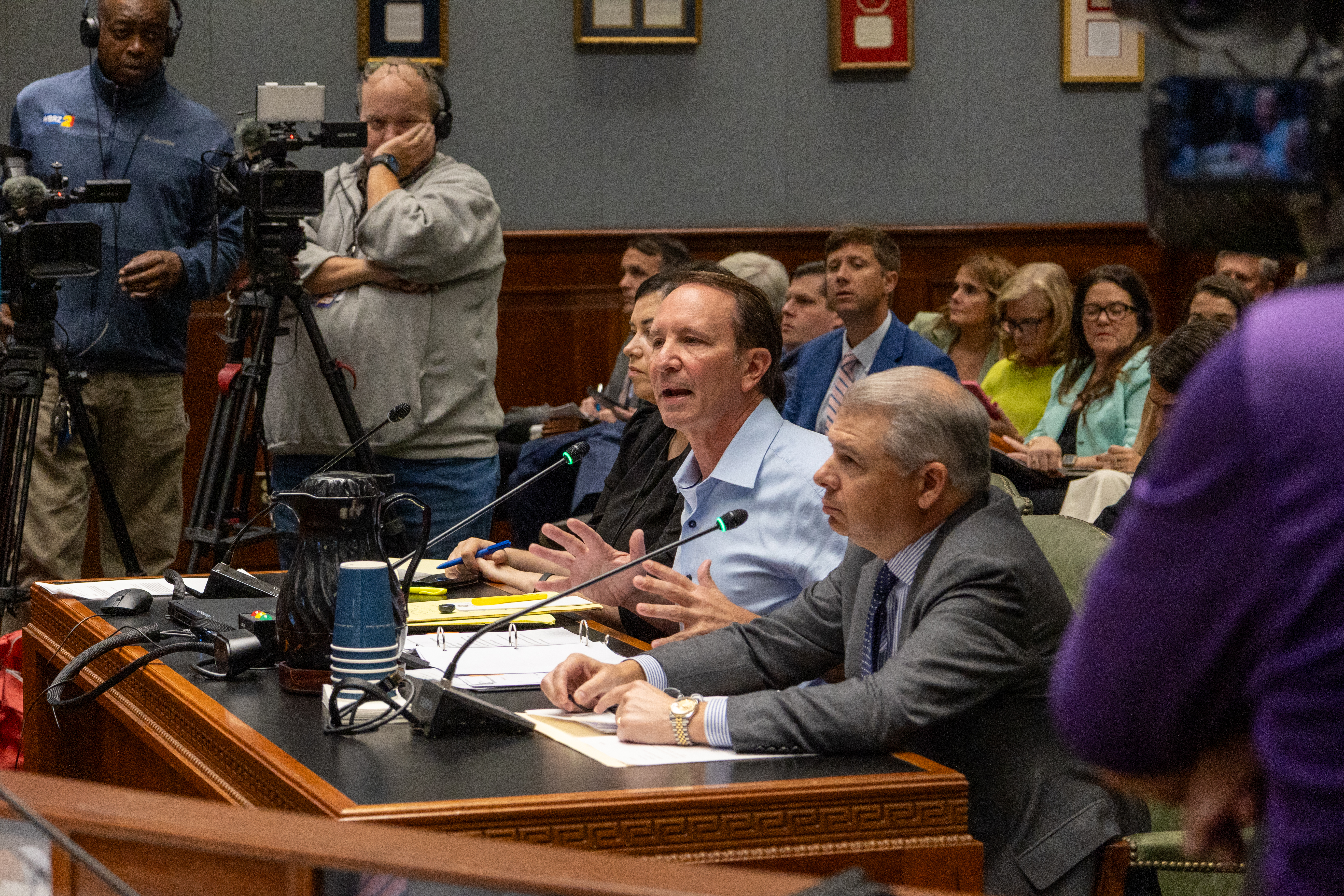 Photograph of Governor Landry testifying regarding property insurance